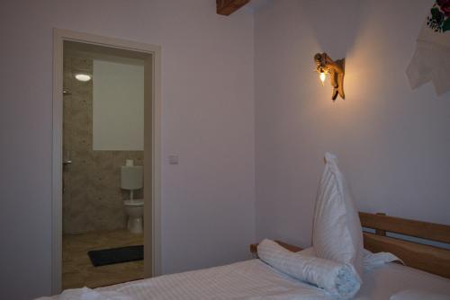 a bedroom with a bed and a bathroom at Casa Traditionala Breb in Breb