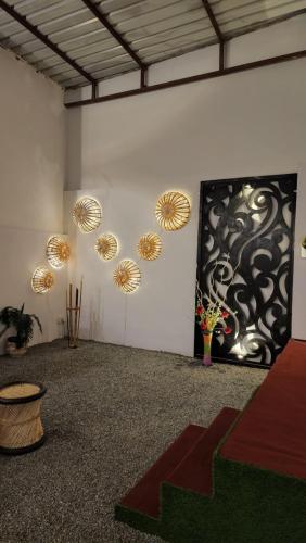 a room with a painting on the wall and lights at Green Club Farm in Ajmer