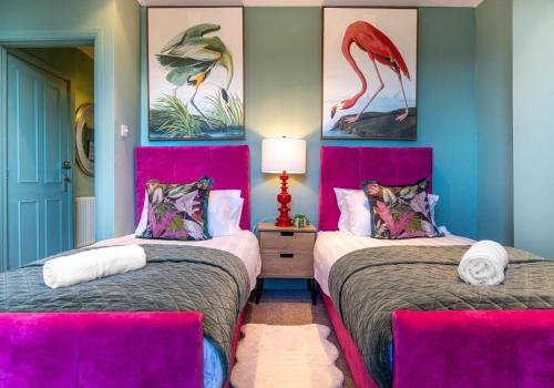 two beds in a room with two pink beds at Dorset Green Two By My Getaways in Brighton & Hove