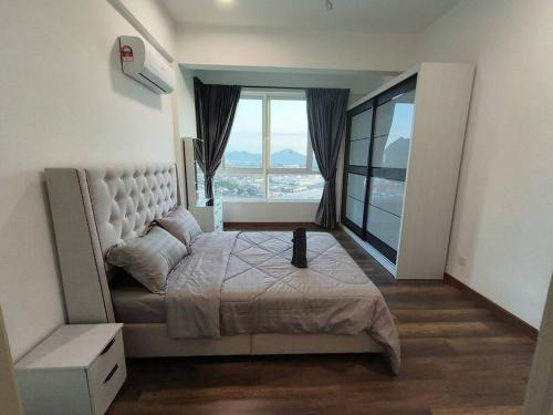 a bedroom with a large bed and a large window at Ipoh D'Festivo Luxury Homestay in Ipoh
