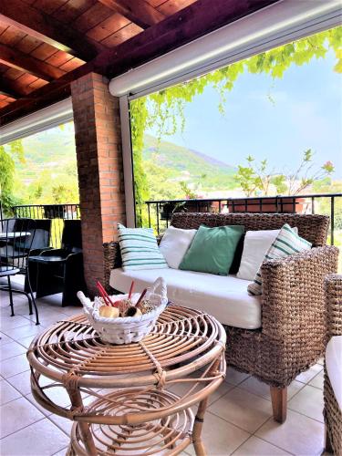a porch with a couch and a table on a patio at Casa Malo' in Ischia