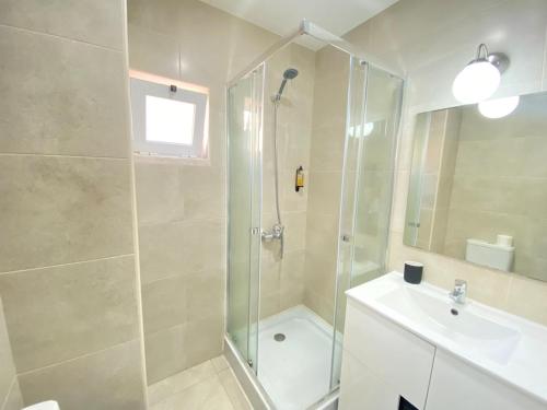 a bathroom with a shower and a sink at Central Station Apartment in Setúbal