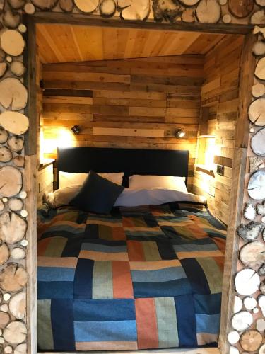 a bedroom with a bed in a log cabin at The Little Stable in Corby