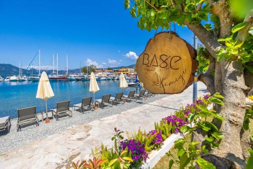 a beach with chairs and a sign that reads base at Base Selimiye in Marmaris