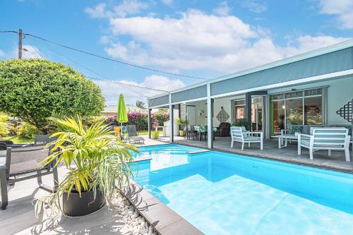 a home with a swimming pool and a house at Villa de rêve avec piscine privée à Baie-Mahault in Baie-Mahault