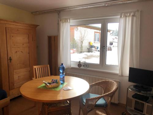 a dining room with a table and a window at Haus Waldeck in Ühlingen-Birkendorf