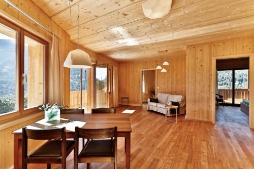 a living room with a table and chairs and a couch at BerglandHof Hotel Ernen in Ernen