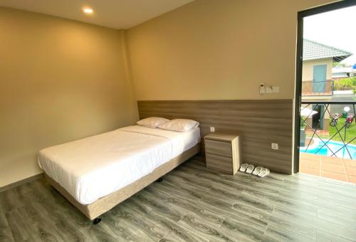 a bedroom with a bed and a large window at ZEN garden in Xuyên Mộc