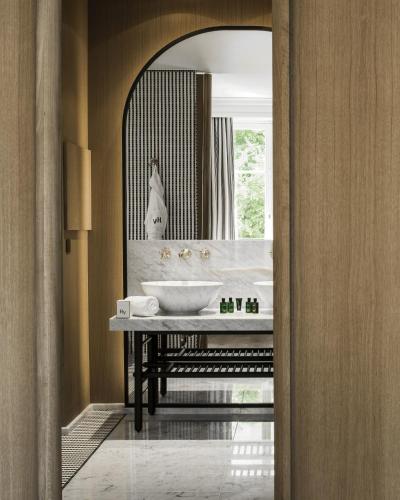 a bathroom with a sink and a mirror at Hôtel Vernet Champs Elysées Paris in Paris
