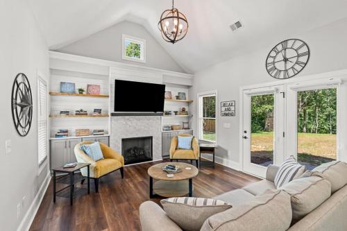 a living room with a couch and a fireplace at Relax, Rewind, Repeat - New Country Cottage in High Point