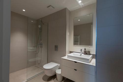 a bathroom with a toilet and a sink and a shower at Belgrade Waterfront Lux 2 in Belgrade