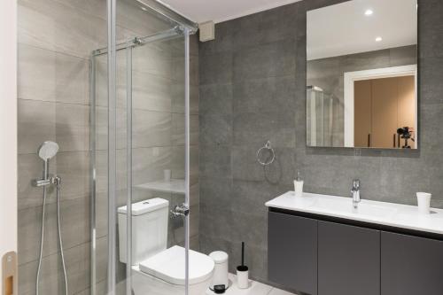 a bathroom with a shower and a toilet and a sink at Voda Luxury Residence #801 in Athens