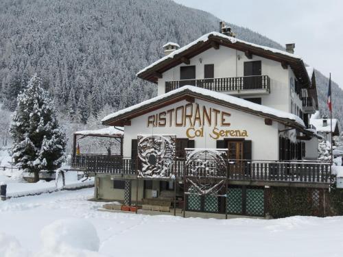 a building with a sign on it in the snow at Hotel Col Serena in Etroubles