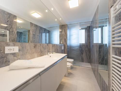 a bathroom with a sink and a shower at Nashira Apartments in Lignano Sabbiadoro