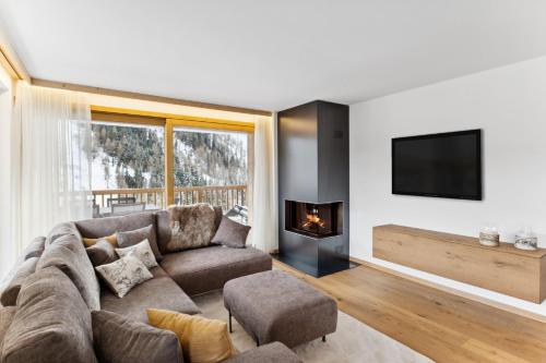 a living room with a couch and a fireplace at Chalet Les Rahâs by Mrs Miggins in Grimentz