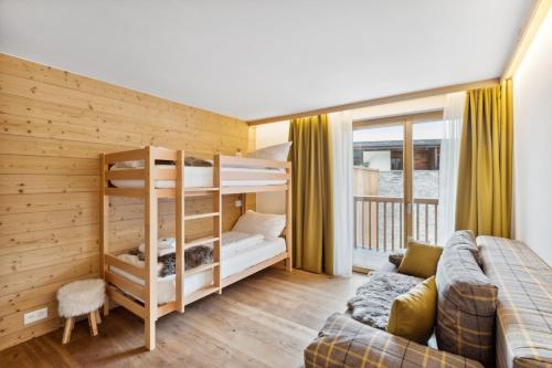 a living room with a bunk bed and a couch at Chalet Les Rahâs by Mrs Miggins in Grimentz