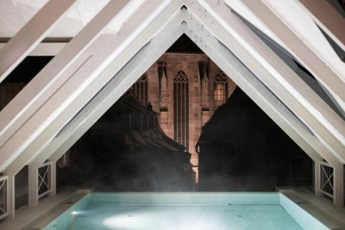 a view of a building from the inside of a pyramid shaped pool at HOTEL & SPA Goldene Rose in Dinkelsbühl