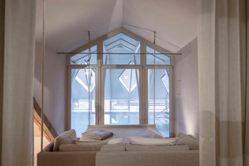 a living room with a couch and a large window at HOTEL & SPA Goldene Rose in Dinkelsbühl