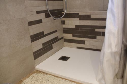 a bathroom with a shower with a drain in it at The Blue Nest - Red Apartment near 5 Terre in La Spezia