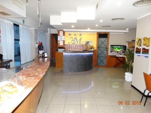 a restaurant lobby with a counter and a bar at Hotel Moderno in Grumello del Monte