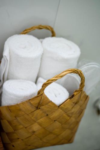 a basket filled with white towels on a table at Anassa Mountain House in Émbonas