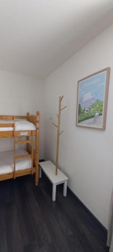 a room with two bunk beds and a poster on the wall at Le Saint Vincent in Apremont