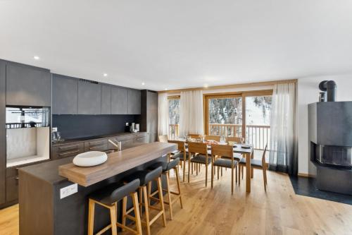 a kitchen with a large wooden table and chairs at Chalet Les Rahâs by Mrs Miggins in Grimentz