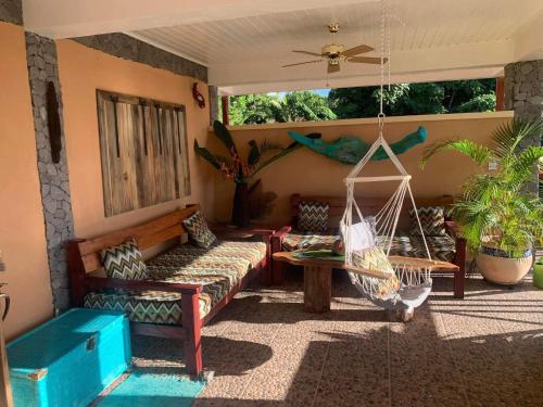 a porch with a hammock and a swing at ORCHID RESORT Ltd in Guillet