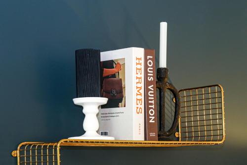 a shelf with a book at Beautiful City Centre Apartment with Free Parking, Fast-Wifi, SmartTV with Netflix and Private Garden by Yoko Property in Milton Keynes