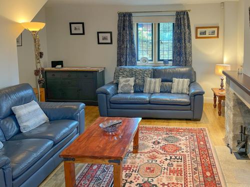 a living room with a couch and a table at Lavender Cottage in Stretton on Fosse