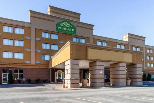 a building with a sign on the front of it at Wingate by Wyndham Marietta Conference Center Ohio in Marietta