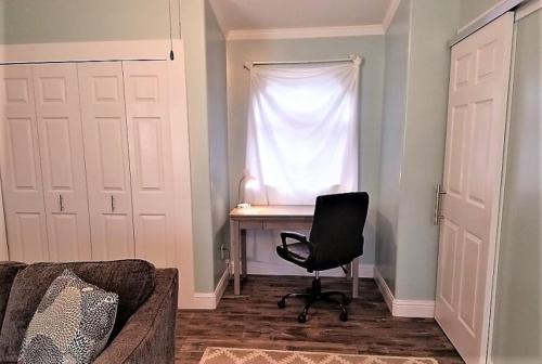 a room with a desk and a chair in front of a window at PA Blue Harbor in Port Angeles