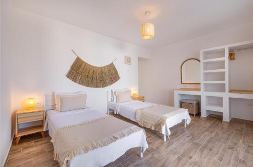 a white room with two beds and a mirror at Base Selimiye in Marmaris