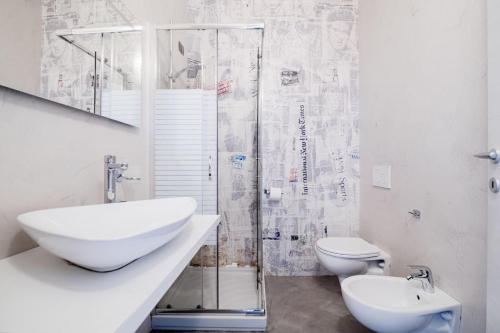 a bathroom with a sink and a toilet and a shower at Be Happy - The House Of Travelers in Como