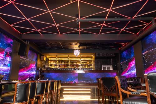 a bar with chairs in a room with purple lights at Hotel BR Grand With Nimo Club Amritsar -5 Mint From Golden Temple in Amritsar