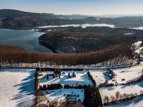 an aerial view of a lake in the snow at Bieszczadzka Pauza in Polańczyk