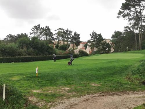 a man and a child playing in a green field at Villa Lala in Amoreira