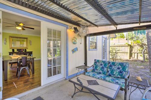 a screened in porch with a couch and a table at Cape Canaveral Cottage with Hot Tub Walk to Beach in Cape Canaveral