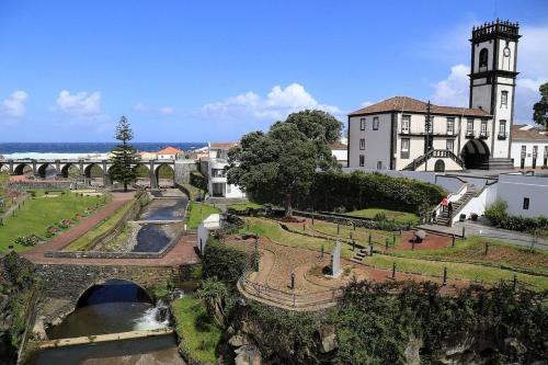 a view of a building with a bridge and a river at Mojo House in Ribeira Grande