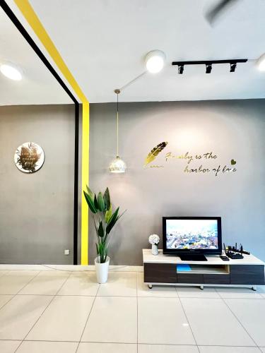 a living room with a tv on a wall at AJ Suites @ Loft Imago KK in Kota Kinabalu