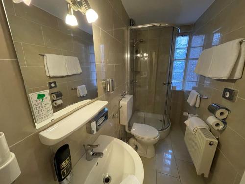 a bathroom with a sink and a toilet and a shower at Hafner Hotel Apartment Self Check-In Anytime in Stuttgart