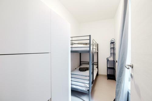 a room with a bunk bed and a refrigerator at Blue Loft - The House Of Travelers in Como