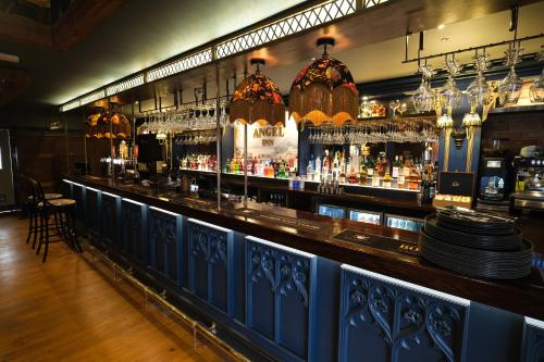 a bar with a lot of bottles of alcohol at The Angel Inn - The Inn Collection Group in Bowness-on-Windermere