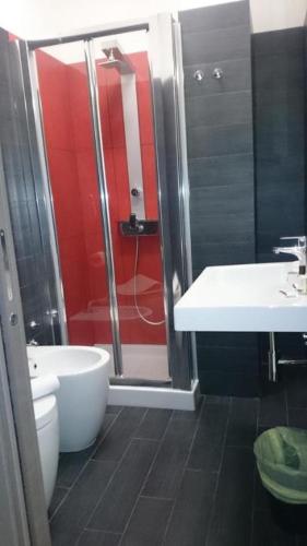 a bathroom with a shower and a toilet and a sink at Rucoli in Brucoli