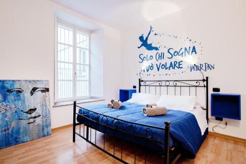 a bedroom with a bed with a blue comforter at Blue Loft - The House Of Travelers in Como