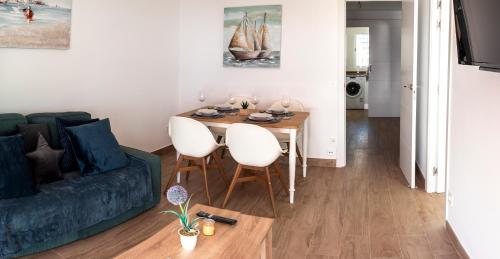 a living room with a table and a couch at BeniBeachHouse in Benidorm