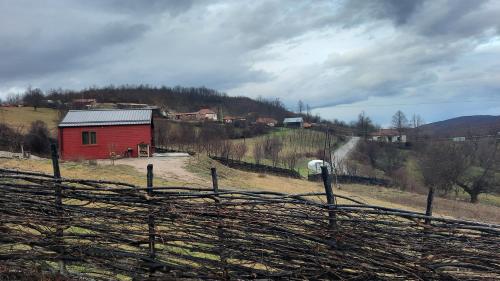 a red barn on the side of a hill at Villa Grashtica - Prishtina City in Pristina