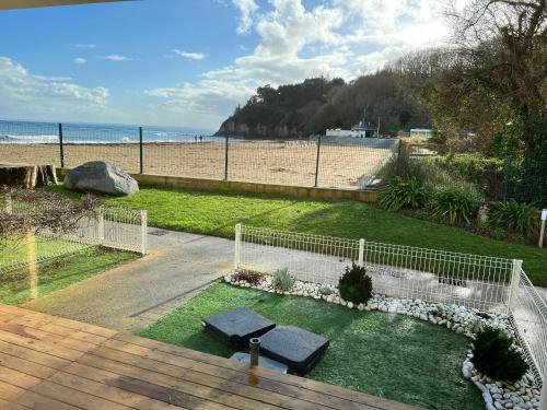 a view of the beach from the balcony of a house at * Le Hameau de la plage * in Étables-sur-Mer
