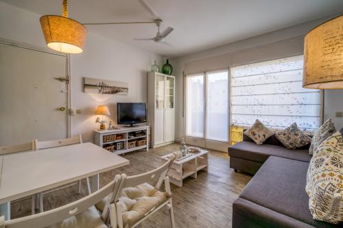a living room with a couch and a table at Vivalidays ilaria - Calella in Calella