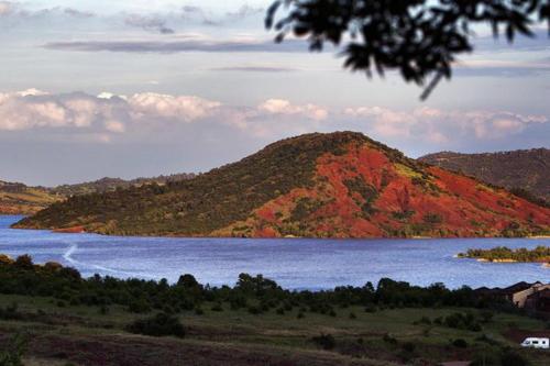 a mountain in the middle of a large body of water at Chambre d'hôtes - Petit ParadyZen - Lac du Salagou in Lacoste